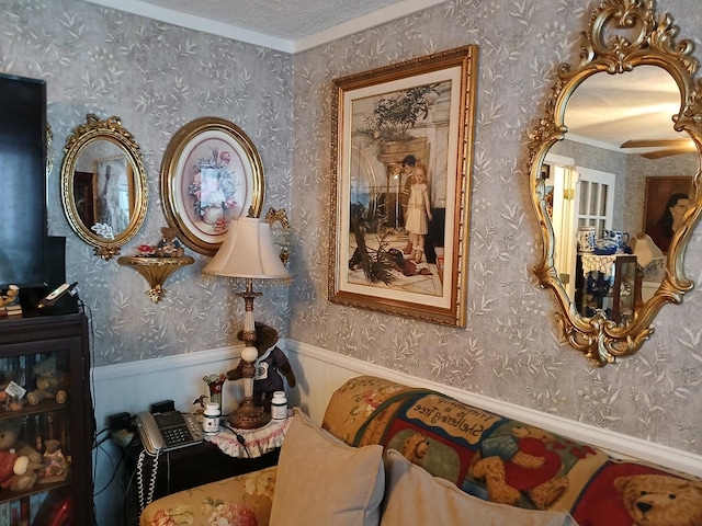 interior details featuring a wainscoted wall, a textured ceiling, and wallpapered walls