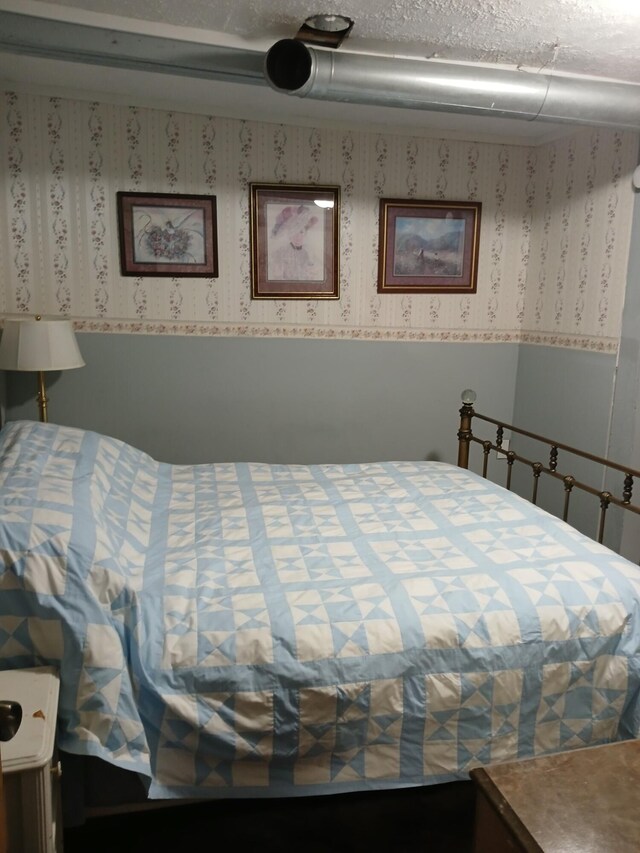 bedroom with wallpapered walls