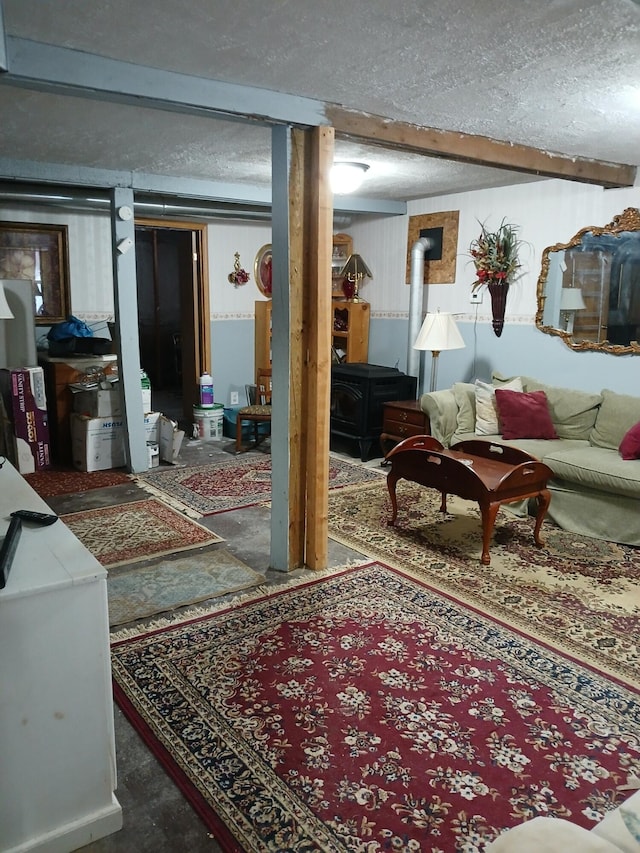 living room with a wood stove and a textured ceiling