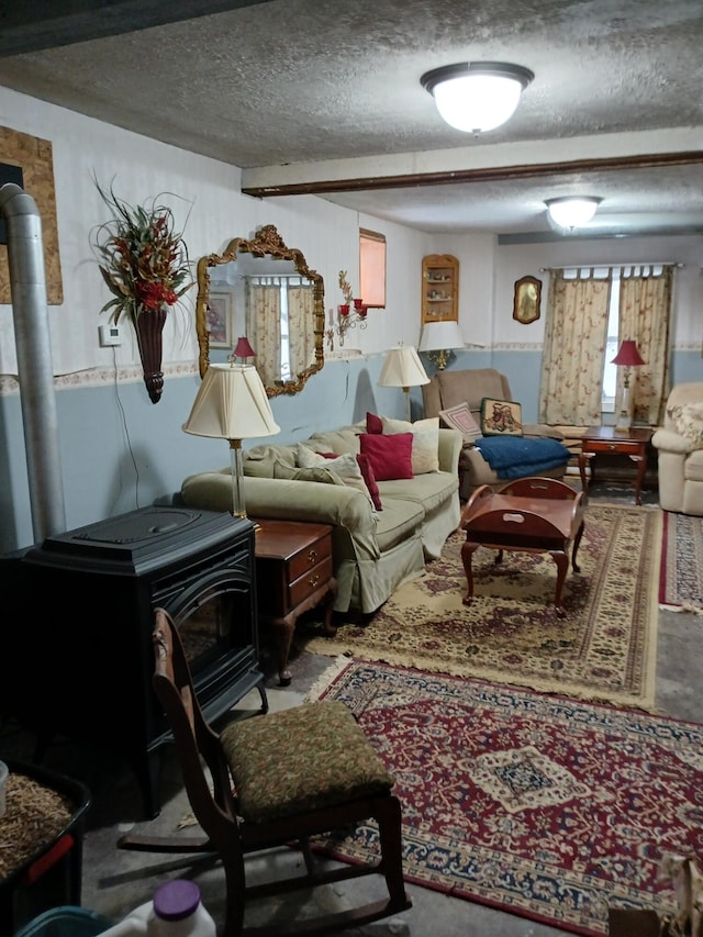 living room featuring a wood stove and a textured ceiling