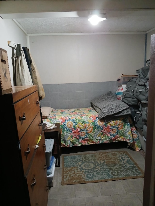 bedroom featuring a textured ceiling and ornamental molding