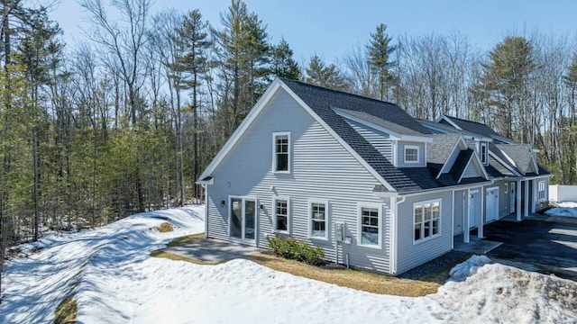 exterior space featuring a shingled roof