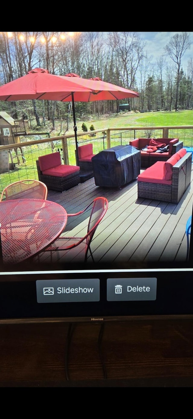 wooden deck featuring a yard