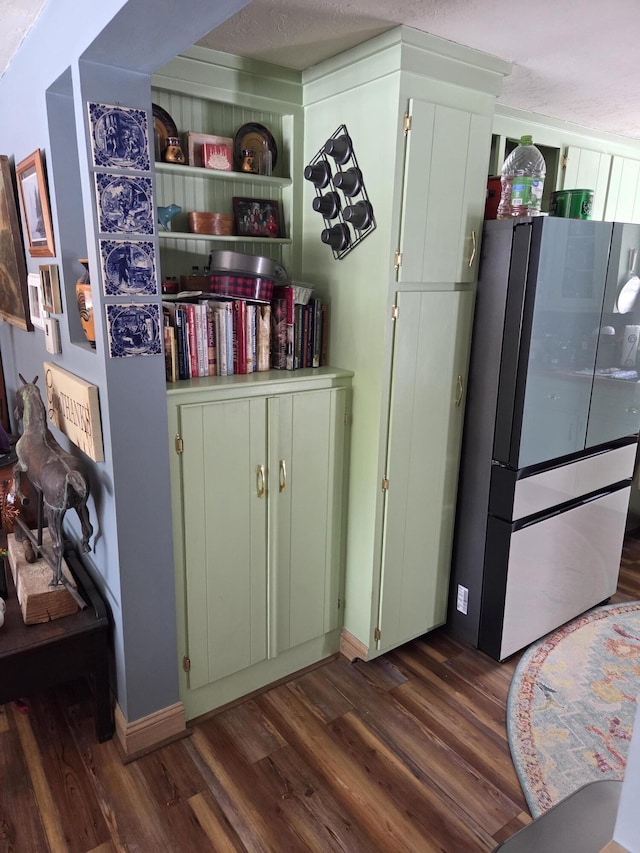 interior space featuring dark wood-type flooring and freestanding refrigerator