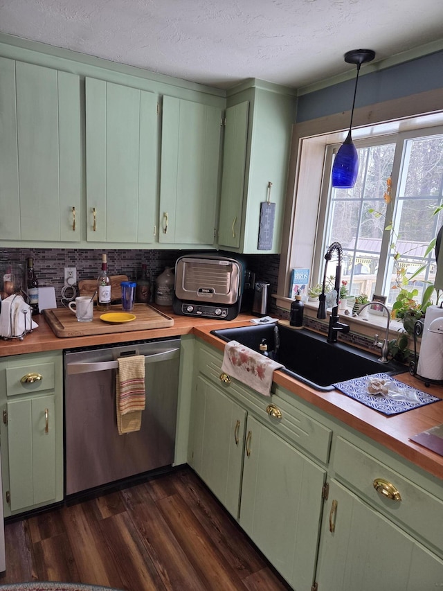 kitchen featuring dishwasher, dark wood-type flooring, a sink, and green cabinetry