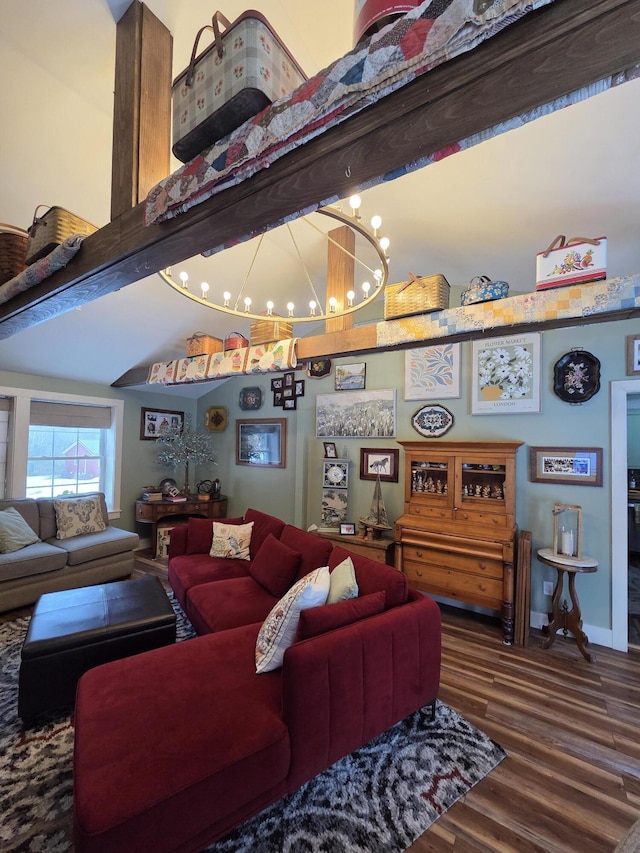 living area featuring baseboards, vaulted ceiling with beams, wood finished floors, and an inviting chandelier