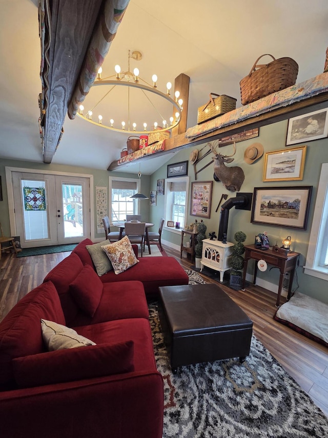 living room with french doors, vaulted ceiling, baseboards, and wood finished floors