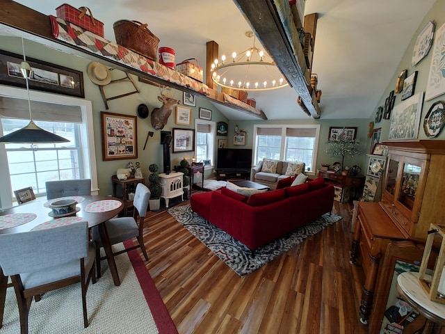 living area with vaulted ceiling with beams, a notable chandelier, and wood finished floors