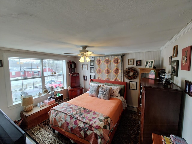 bedroom featuring a baseboard heating unit, ceiling fan, a textured ceiling, and crown molding