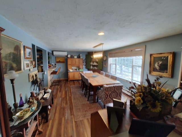 dining space featuring dark wood-style flooring and a wall mounted air conditioner