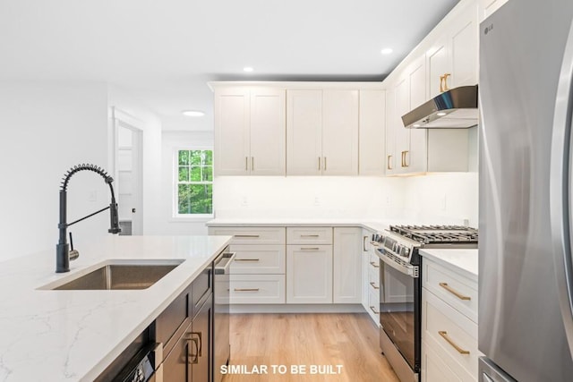 LOT11 Raspberry Ln, Topsham, ME 04086 - kitchen featuring light wood finished floors, stainless steel appliances, under cabinet range hood, a sink, and light stone counters