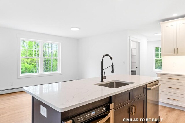 LOT11 Raspberry Ln, Topsham, ME 04086 - kitchen featuring light wood-type flooring, stainless steel dishwasher, a center island with sink, a sink, and light stone countertops