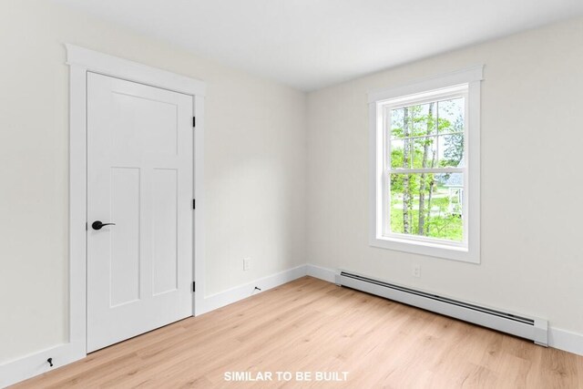 LOT11 Raspberry Ln, Topsham, ME 04086 - spare room featuring baseboards, wood finished floors, and a baseboard radiator
