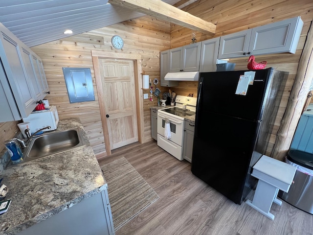 35 Swan Ln, Dexter, ME 04930 - kitchen with white electric stove, a sink, freestanding refrigerator, wooden walls, and under cabinet range hood