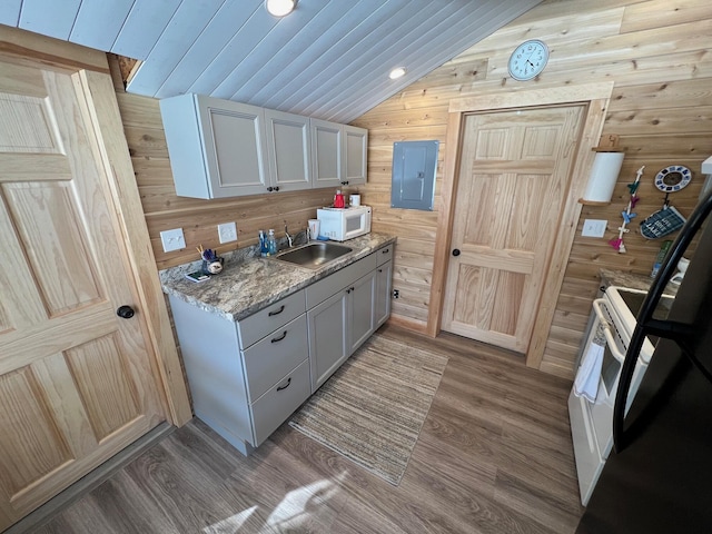 35 Swan Ln, Dexter, ME 04930 - kitchen with a sink, white microwave, lofted ceiling, wood finished floors, and wooden walls