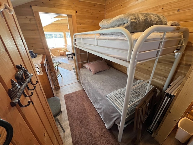 35 Swan Ln, Dexter, ME 04930 - bedroom with wood walls and light wood-type flooring