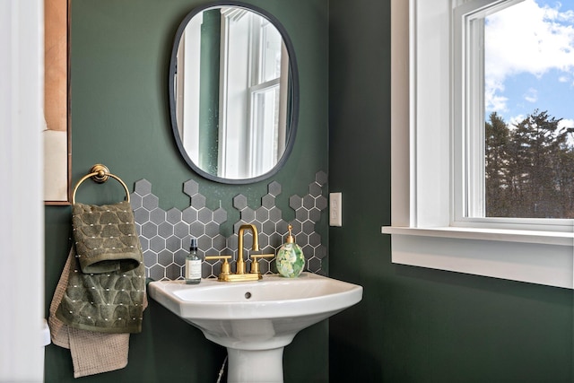 bathroom featuring tasteful backsplash and a sink