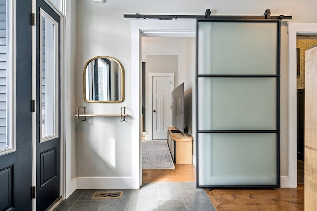 interior space with visible vents, baseboards, and wood finished floors