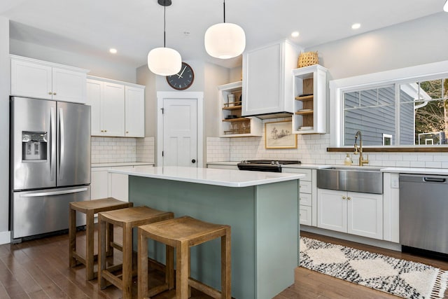 kitchen featuring open shelves, a sink, stainless steel appliances, light countertops, and white cabinetry