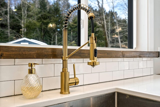 interior details with tasteful backsplash and a sink