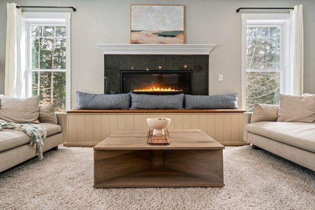 living area featuring a tiled fireplace