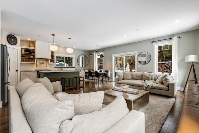 living room featuring hardwood / wood-style flooring, recessed lighting, and a healthy amount of sunlight