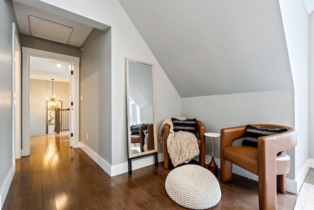 sitting room featuring baseboards, lofted ceiling, and hardwood / wood-style flooring