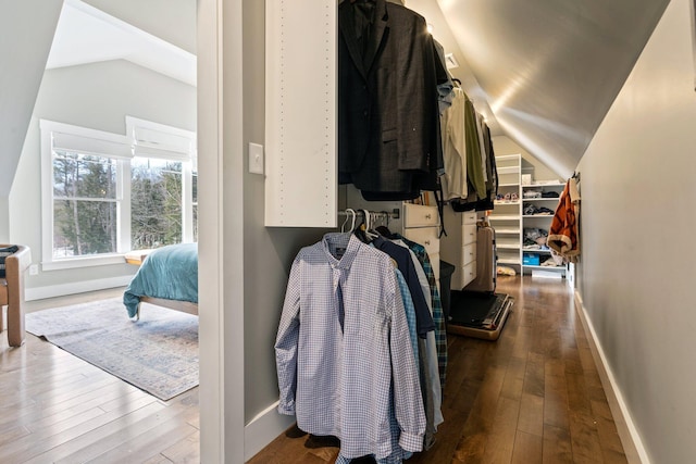 walk in closet featuring hardwood / wood-style flooring and lofted ceiling