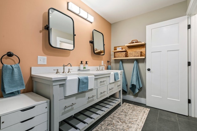 bathroom featuring tile patterned floors, double vanity, and a sink