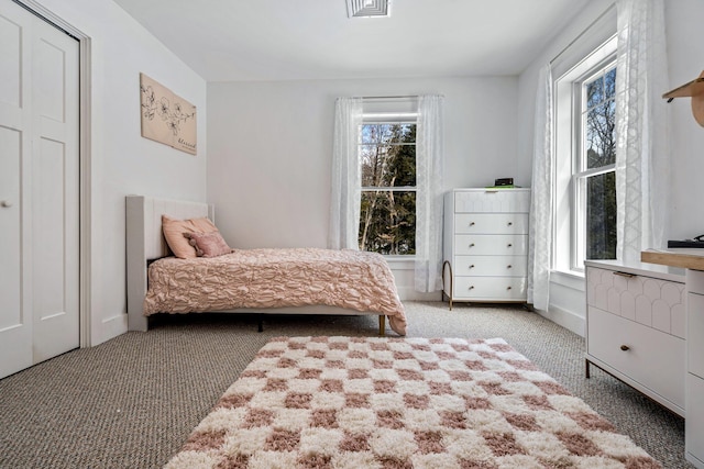 carpeted bedroom with visible vents and baseboards