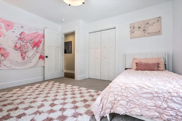 carpeted bedroom with baseboards and a closet