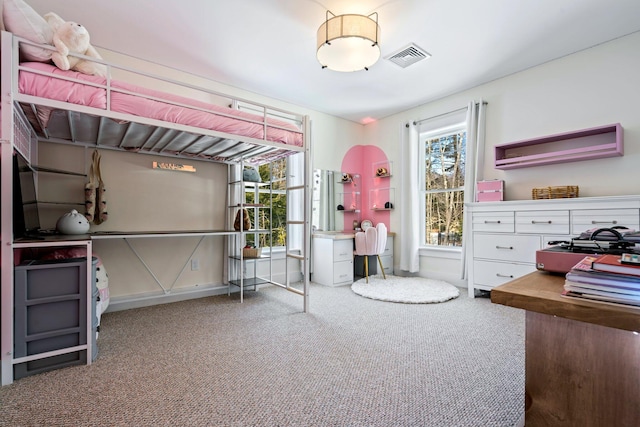 carpeted bedroom featuring visible vents