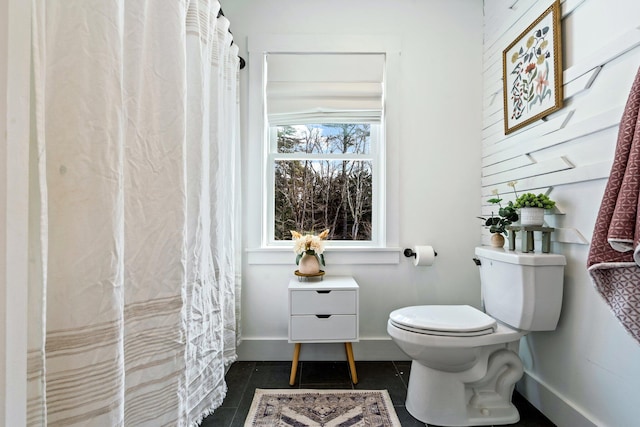 full bathroom with tile patterned flooring, toilet, and baseboards