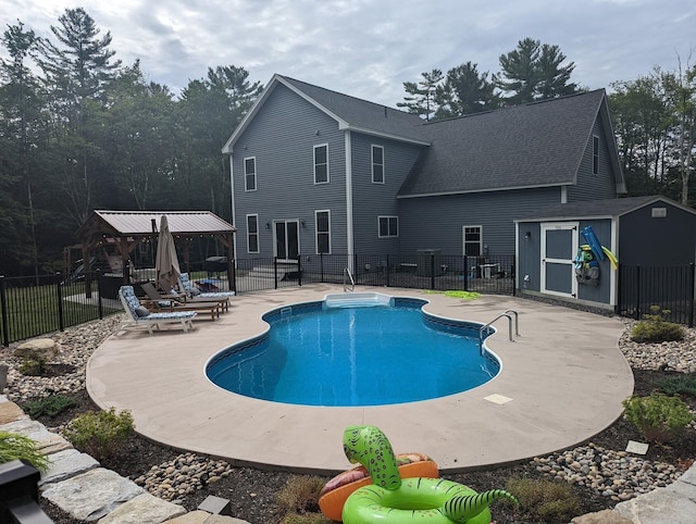 view of pool with a gazebo, a fenced in pool, a patio area, and fence