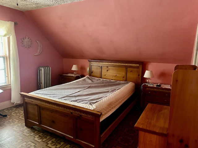 bedroom with radiator, vaulted ceiling, a textured ceiling, and baseboards