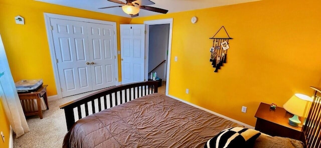 bedroom featuring ceiling fan, a closet, carpet, and baseboards