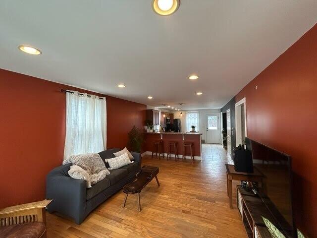 living room with recessed lighting and light wood-style flooring