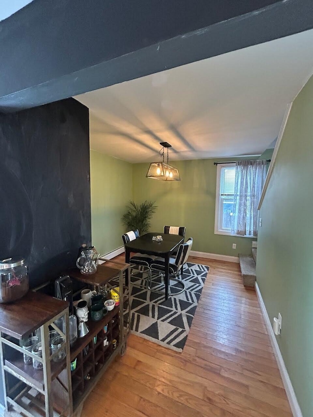 dining room featuring wood-type flooring and baseboards