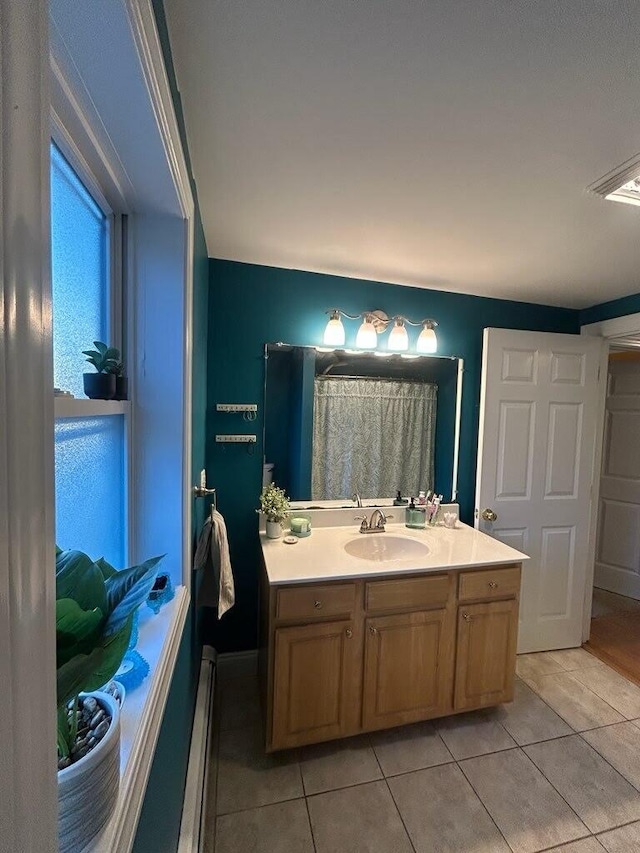 full bathroom featuring tile patterned flooring and vanity