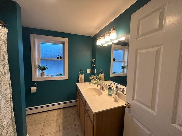 full bath with baseboards, vanity, a baseboard heating unit, and tile patterned floors