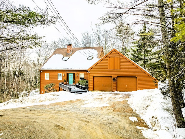 view of front of house with a garage and a chimney