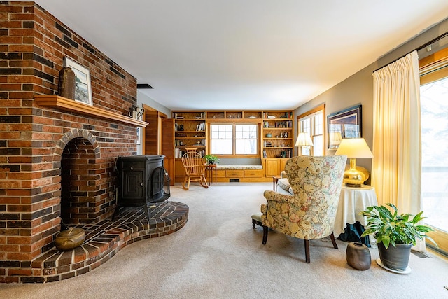 living area featuring a wood stove and carpet floors