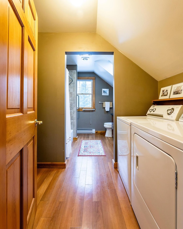 laundry area featuring a baseboard radiator, laundry area, separate washer and dryer, baseboards, and light wood-style floors