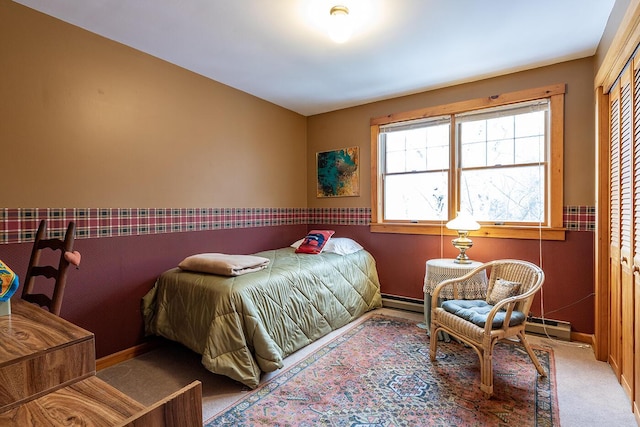 carpeted bedroom featuring a closet and baseboards