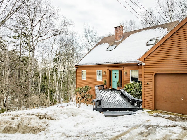 view of front of house with a chimney and an attached garage