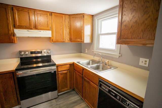 kitchen featuring electric stove, a sink, black dishwasher, ventilation hood, and light countertops