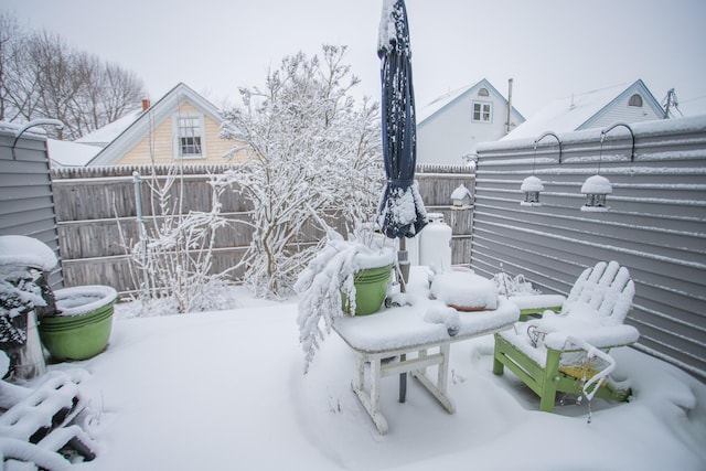 yard covered in snow featuring fence