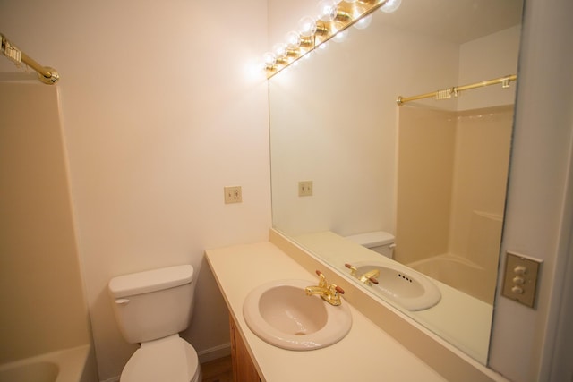 bathroom featuring vanity, toilet, and walk in shower