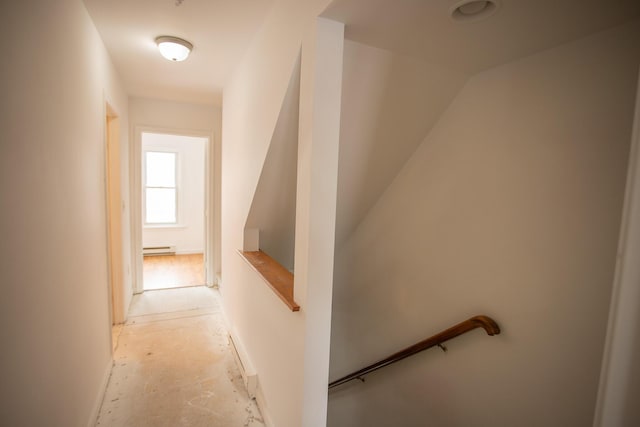 corridor with an upstairs landing and baseboard heating