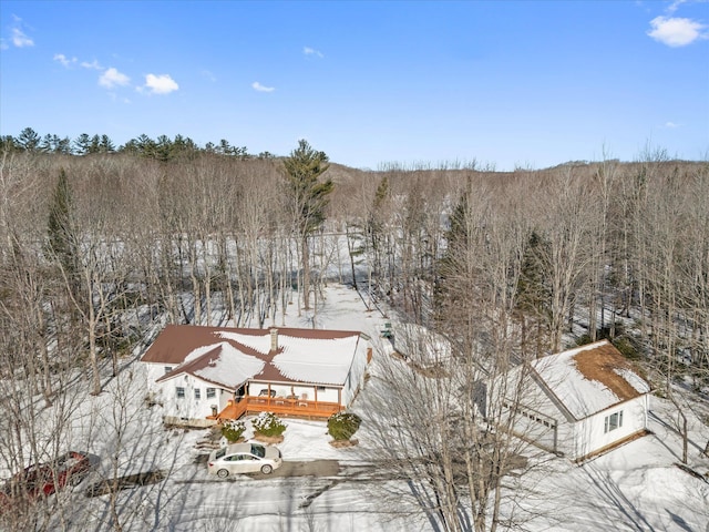 snowy aerial view featuring a view of trees